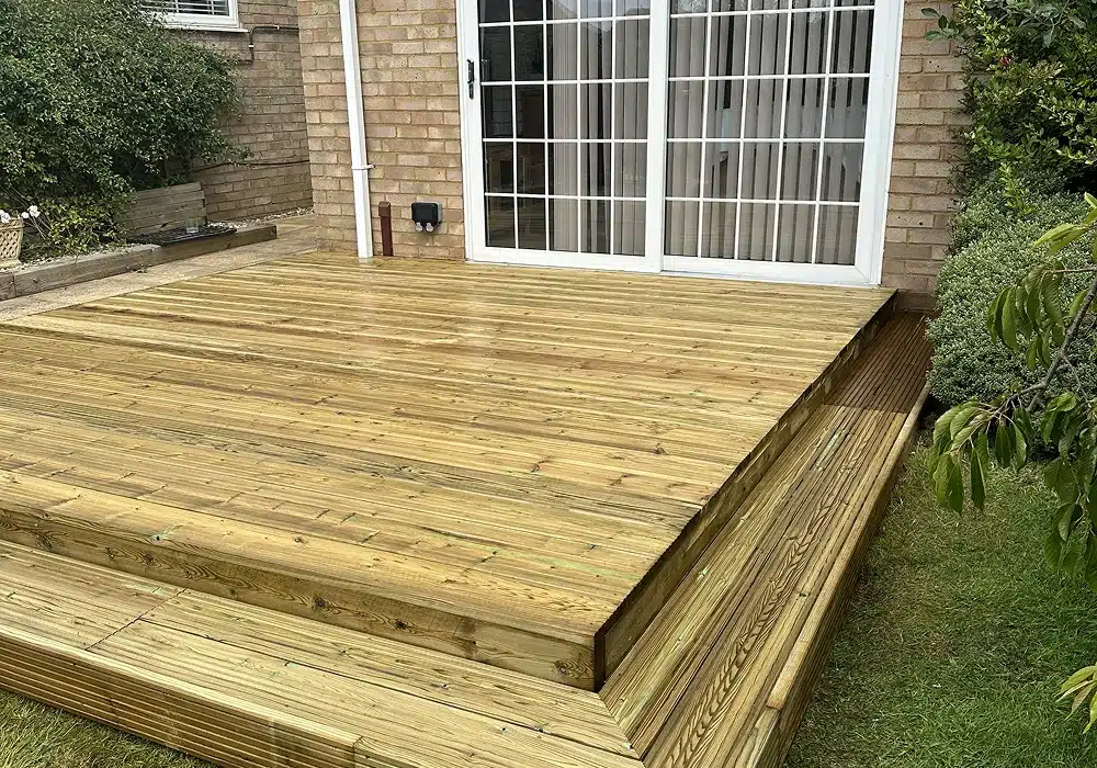 Raised timber deck in a garden outside patio doors