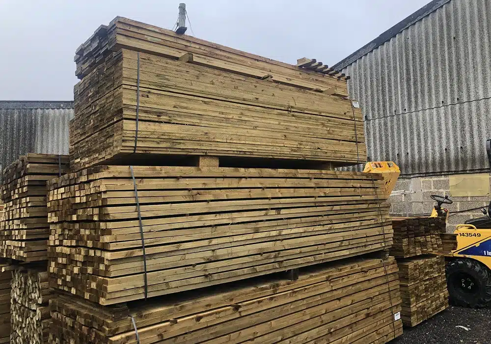 Stacks of timber planks stored in an outdoor yard
