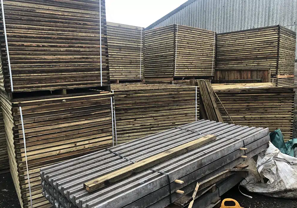 Stacks of timber planks and boards stored outdoors in a yard